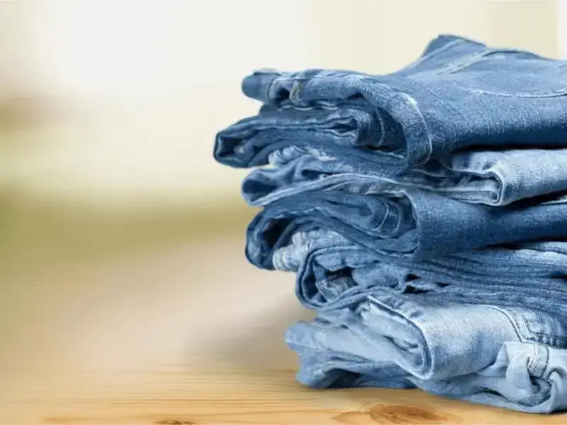Denim-jeans-collection-folded-on-table — premium-styles-for-men-and-women